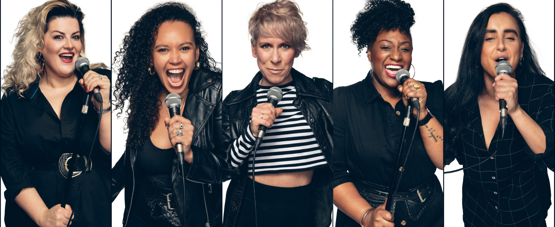 The cast of 5 women singing into their microphones