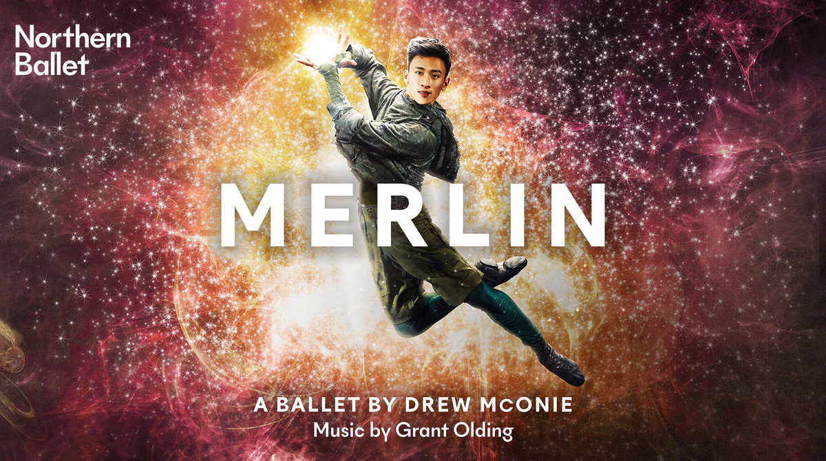 A dancer poses, mid-leap, facing the camera. His hands close together, he seems to be holding light. Behind him is a background of dark pinks and oranges with flecks of light emerging from the centre. Text reads “Northern Ballet: Merlin. A ballet by Drew McOnie, music by Grant Olding”.